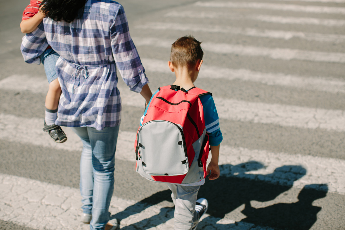 child crossing street with mom
